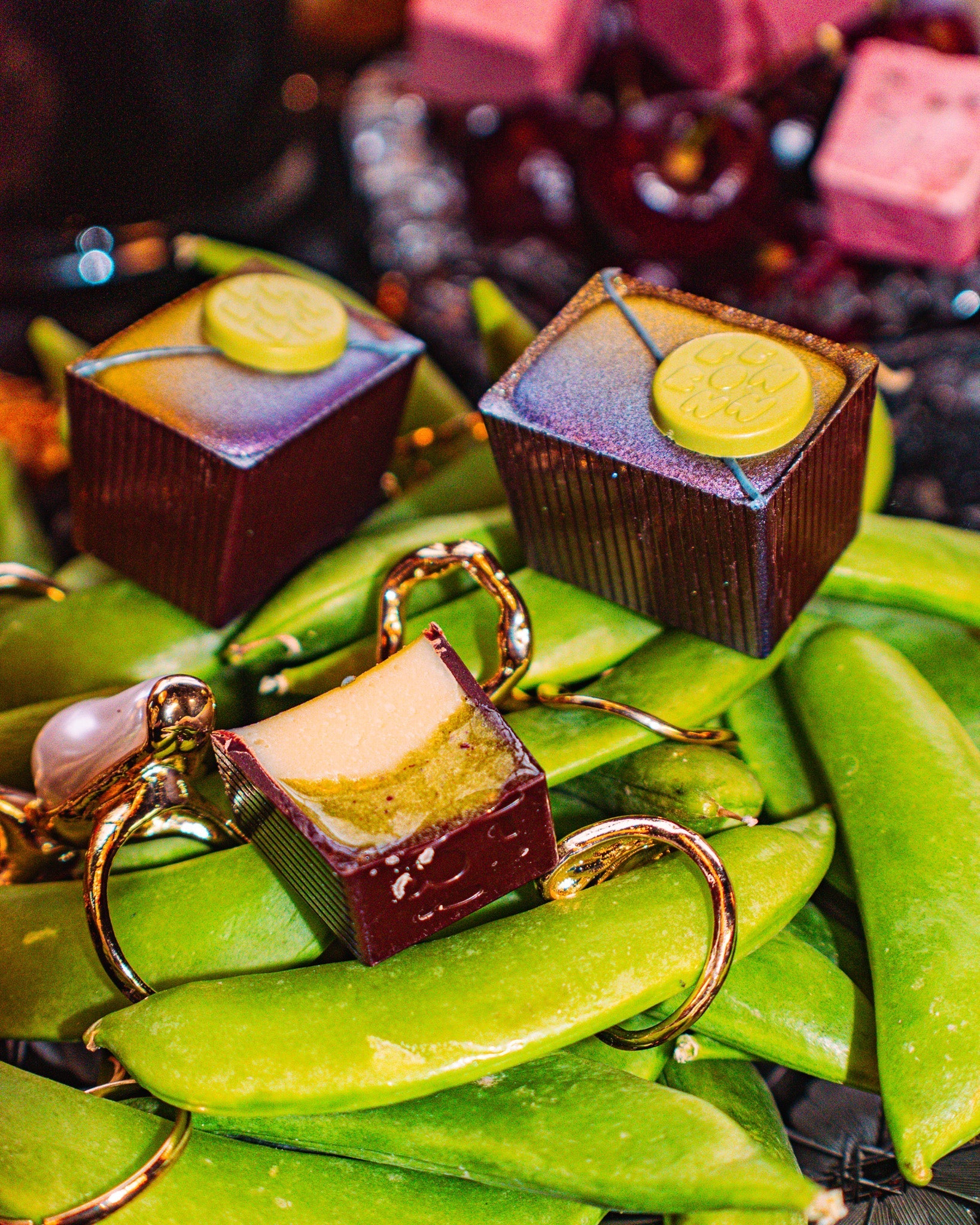 Three Peas Be Mine Bons on a bed of sweet peas with golden rings scattered around