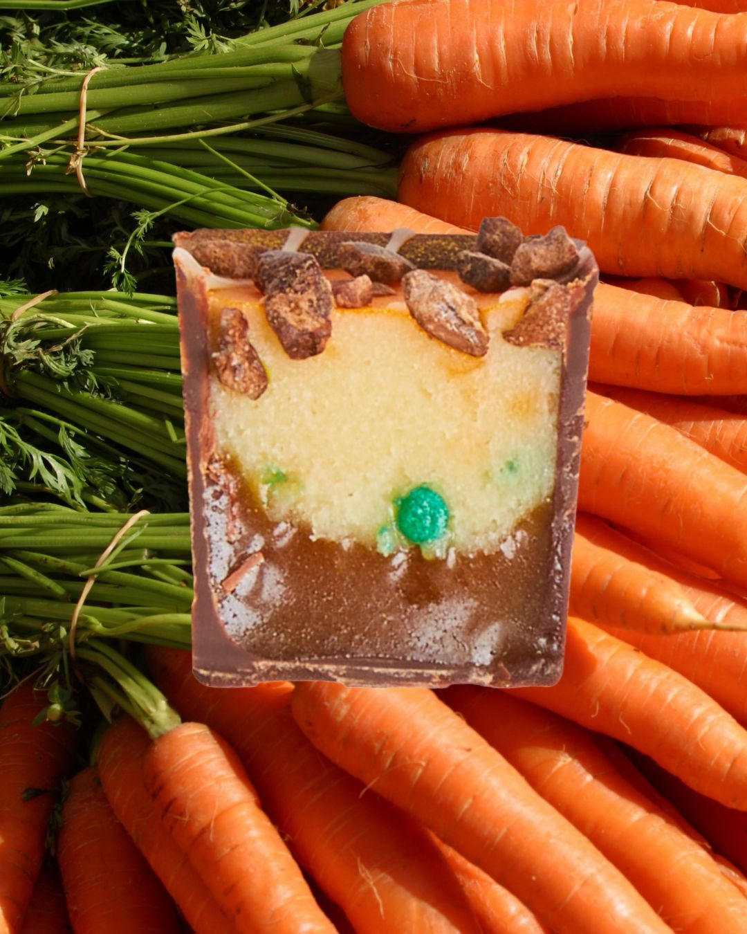 Cross cut of a 1 Carrot Gem Bon with an image of orange carrots as the background