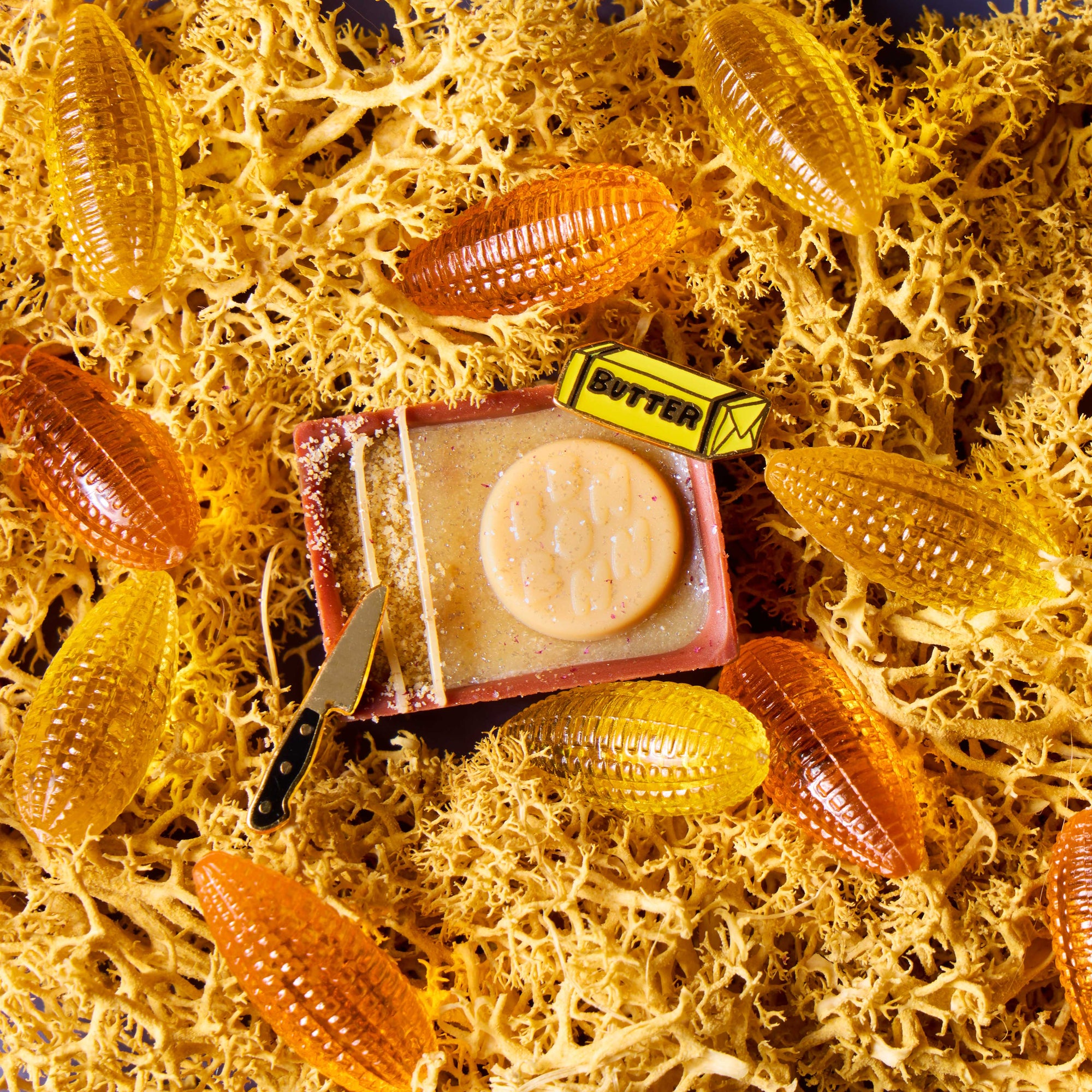 My Butter Half Bon on top of a yellow textured background with small corn decorations