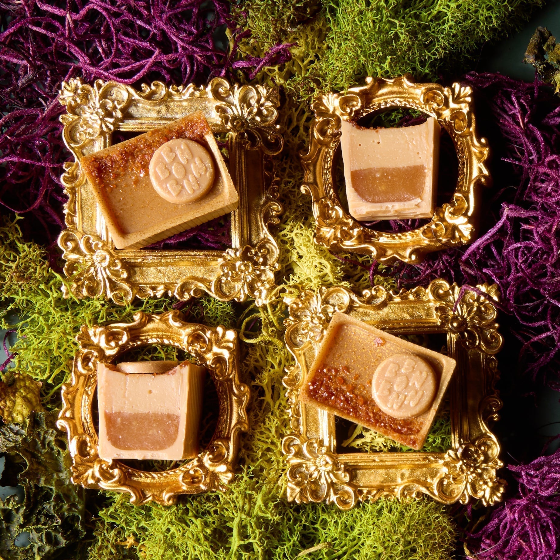 Four Four Play Bons and Halves on a green and purple moss backdrop