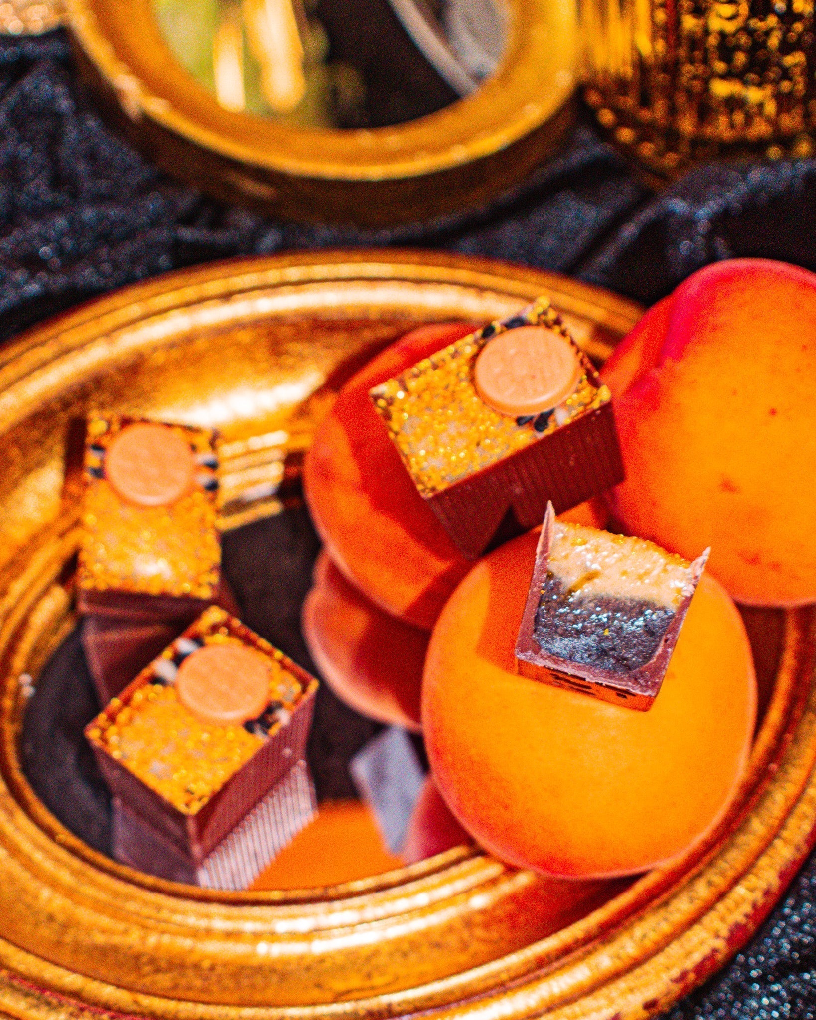 3 Bons on a mirror with 3 apricots on the side.