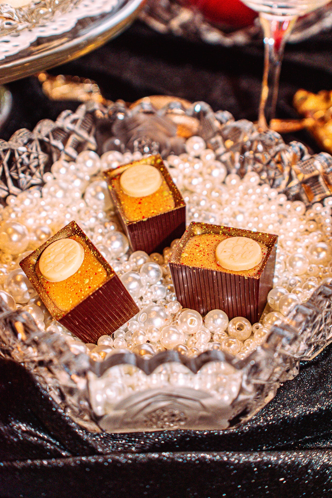 Three Bons in a glass bowl full of beads