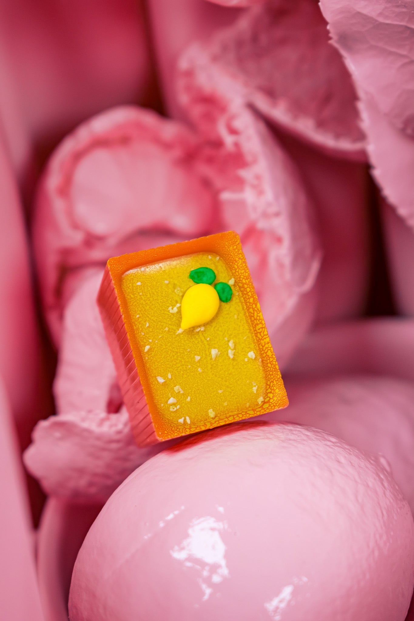 One Bon on top of pink egg with pink background