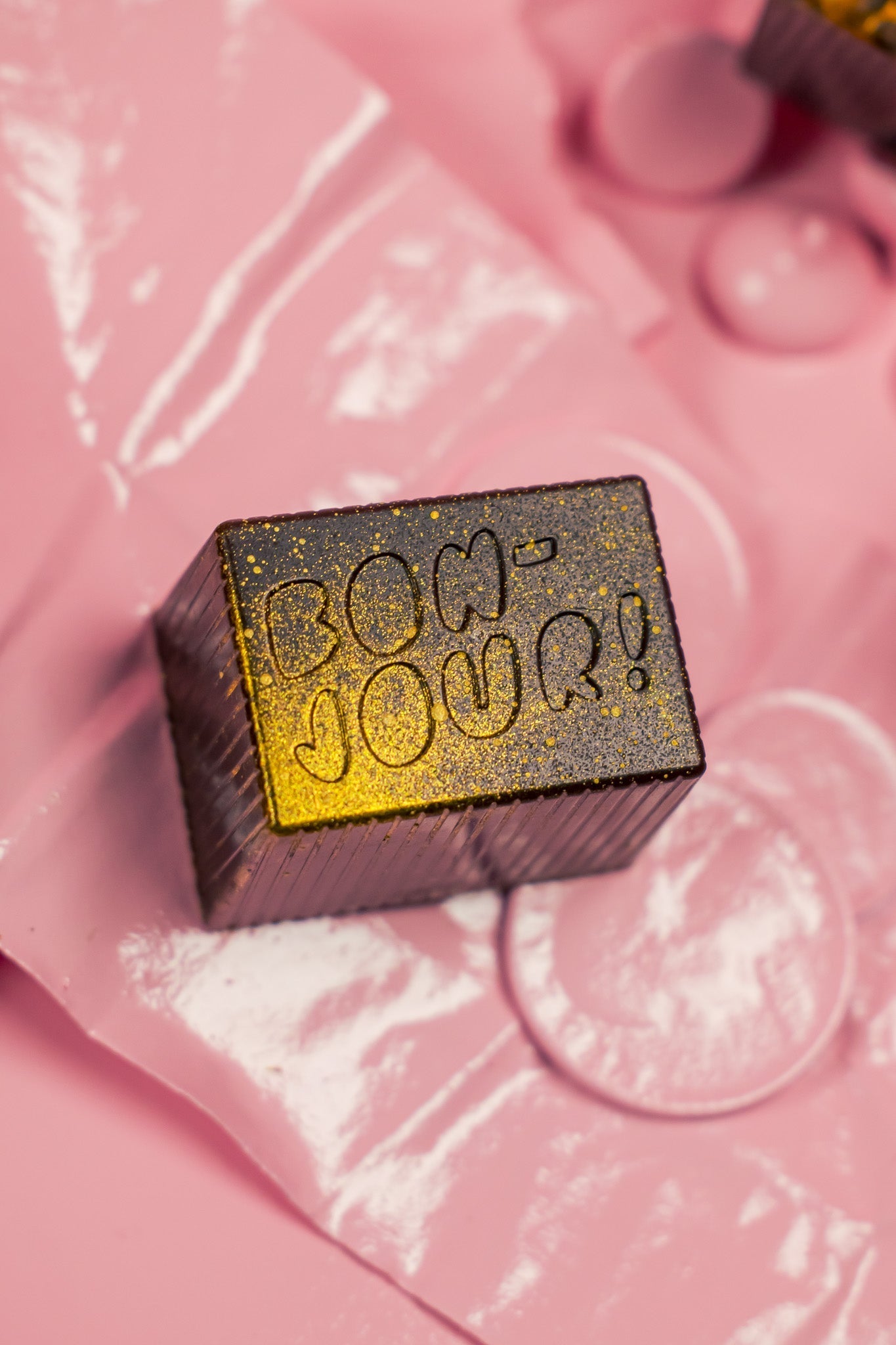 Bon on top of pink bag with blurred pink background.