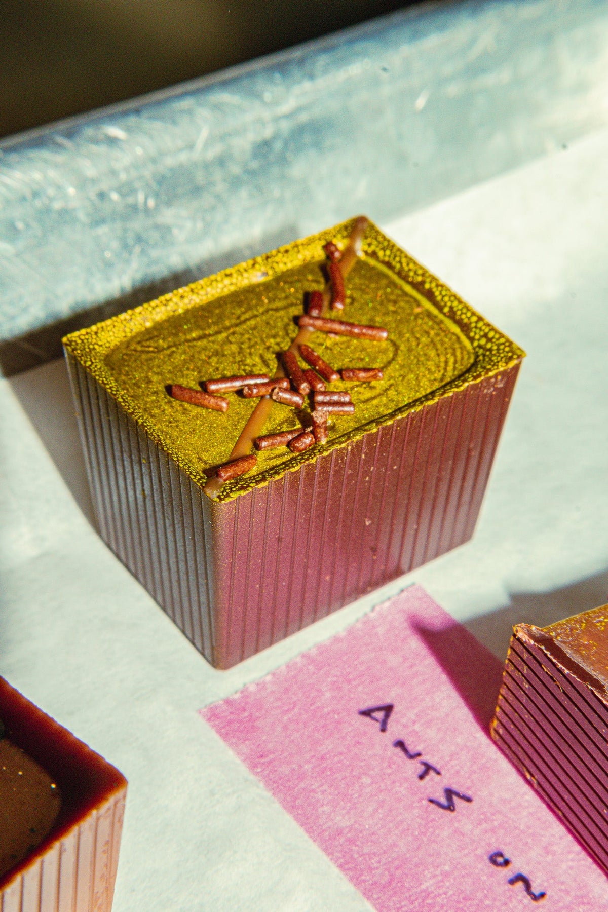 Bon on a tray with other Bons off to the side. Pink masking tape with "Ants on..." 