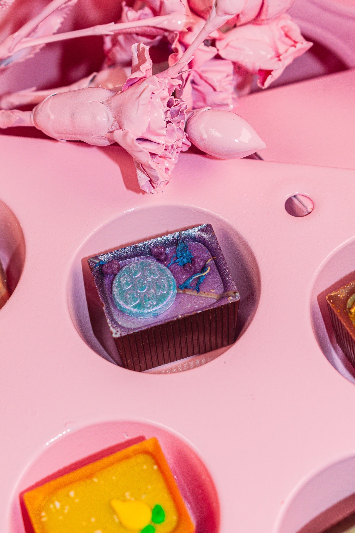 A London Fog Bon in the divot of a pink muffin tin. 