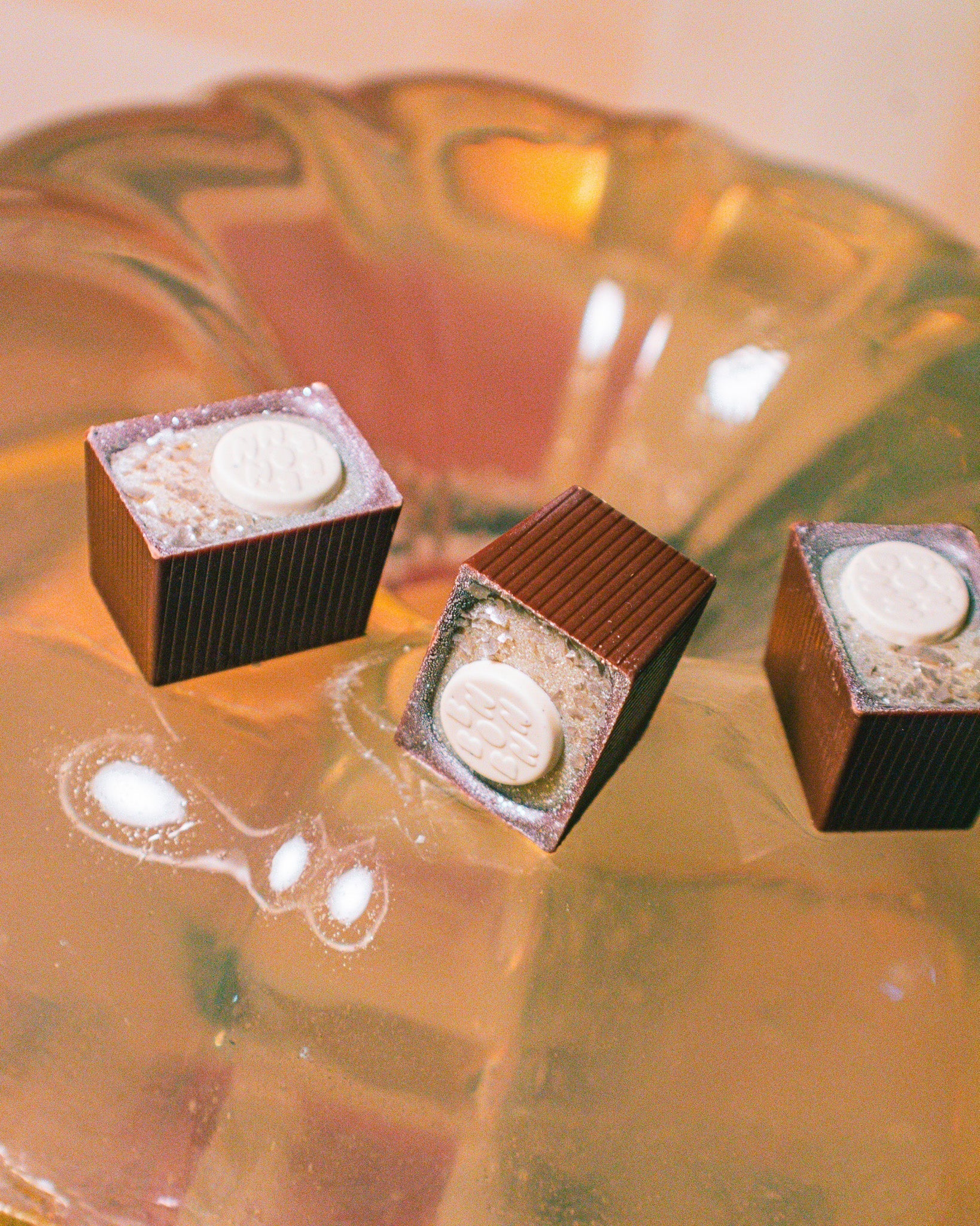 Three Nuts for Nougat Bons on a glass table.