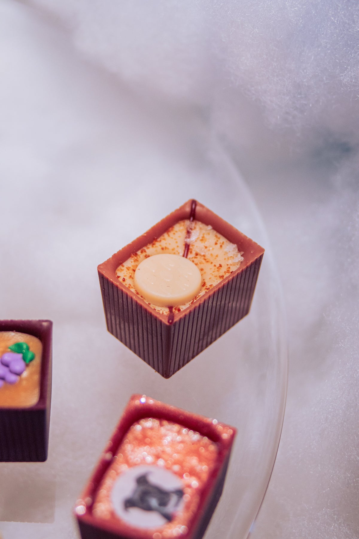 3 Bons on glass table with blurred background