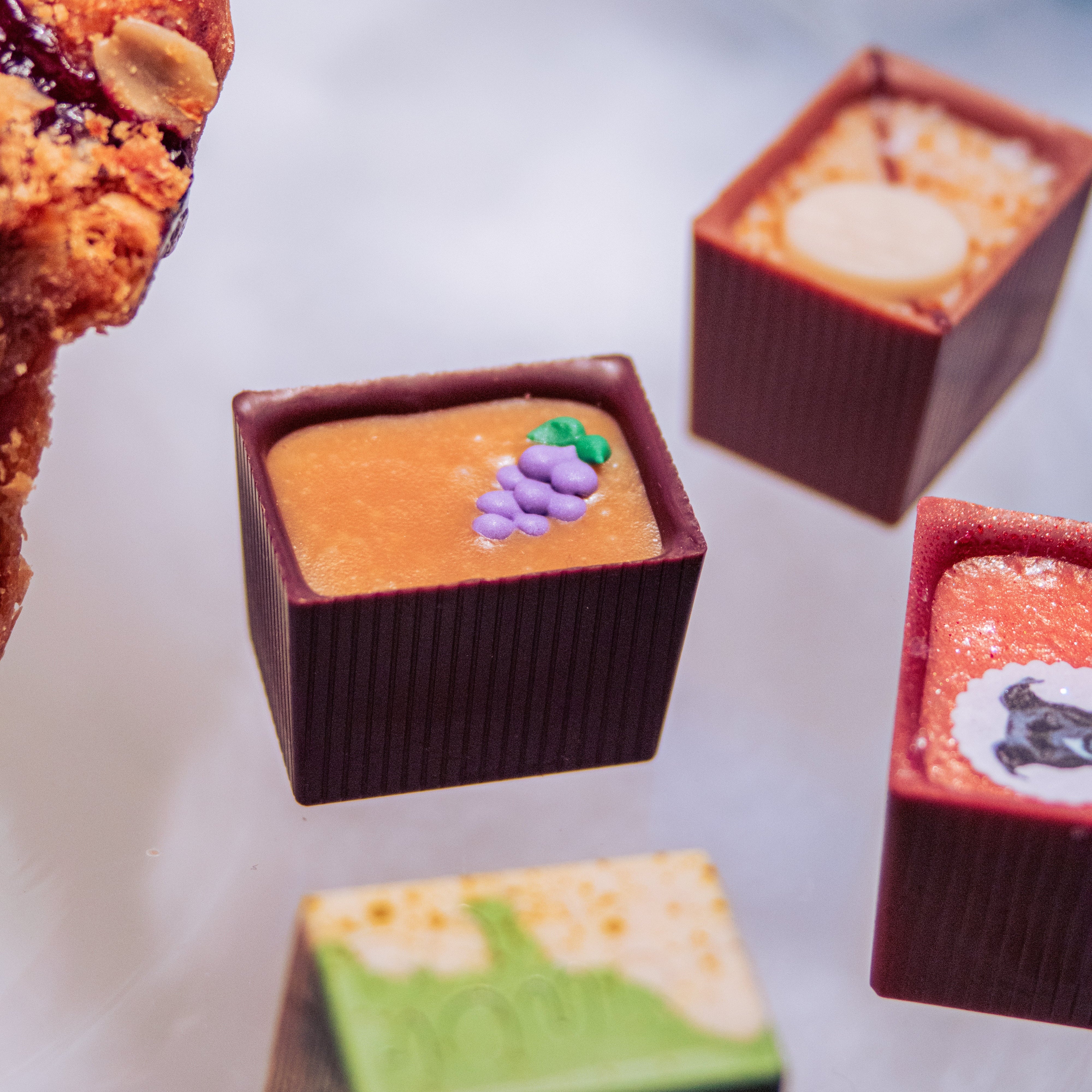 Four Bons on a glass table with a bit of pie off to the side slightly out of frame