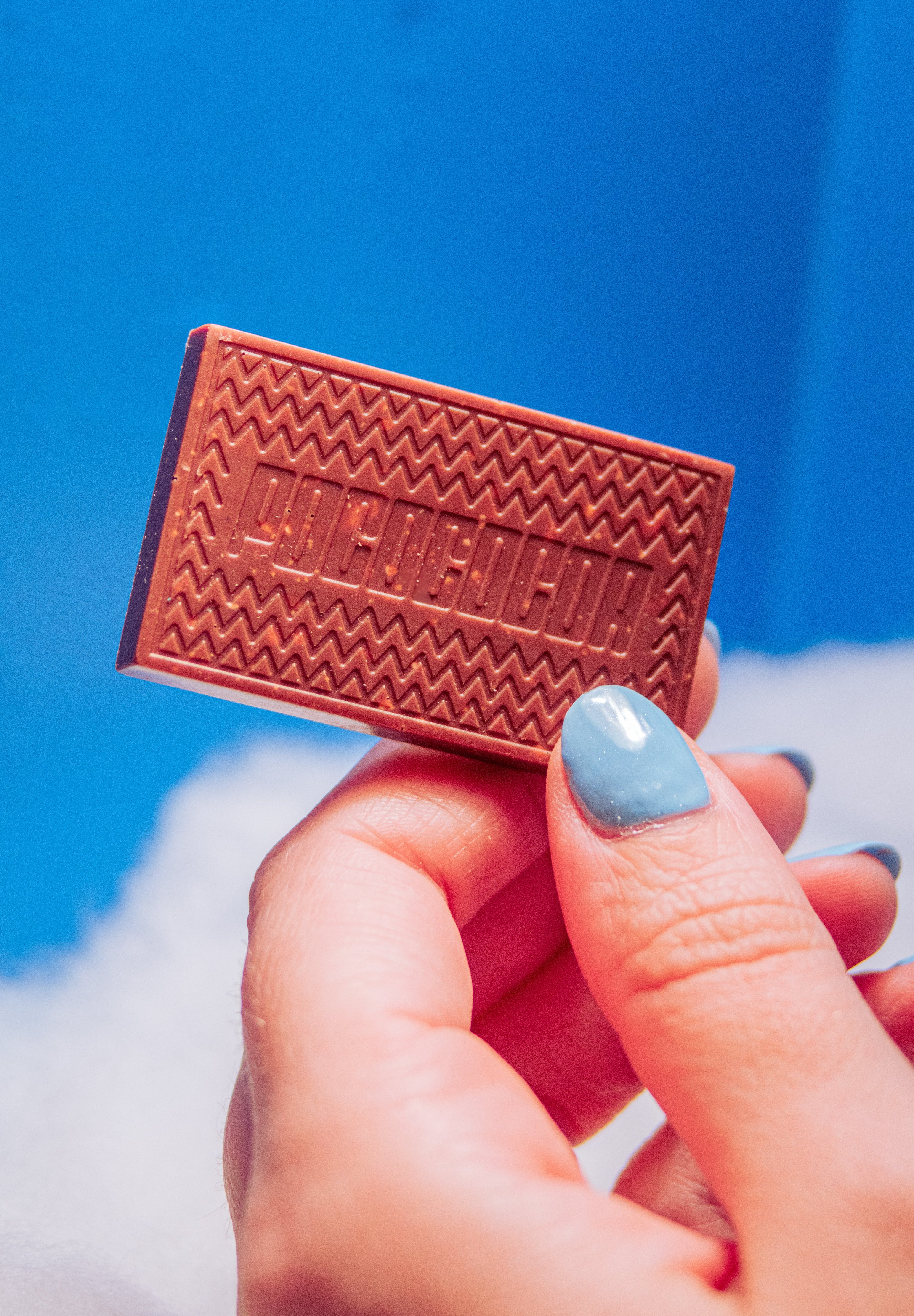 hand holding a bar of chocolate in the ski