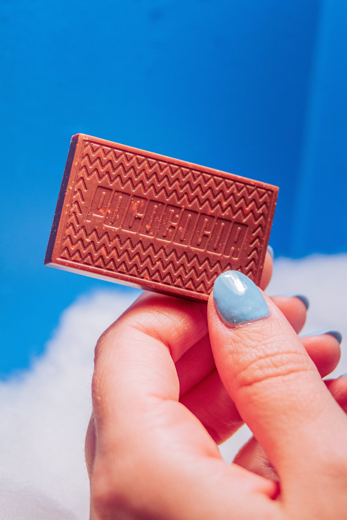 hand holding a bar of chocolate in the ski