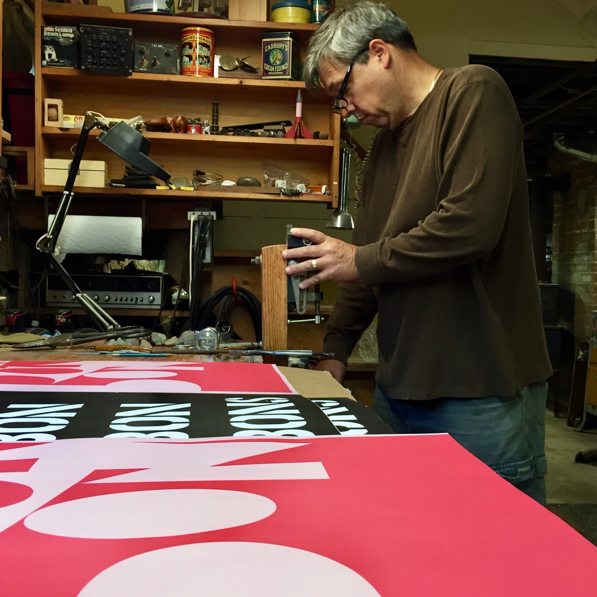Our founder's dad building retro Bon shop signage in a basement