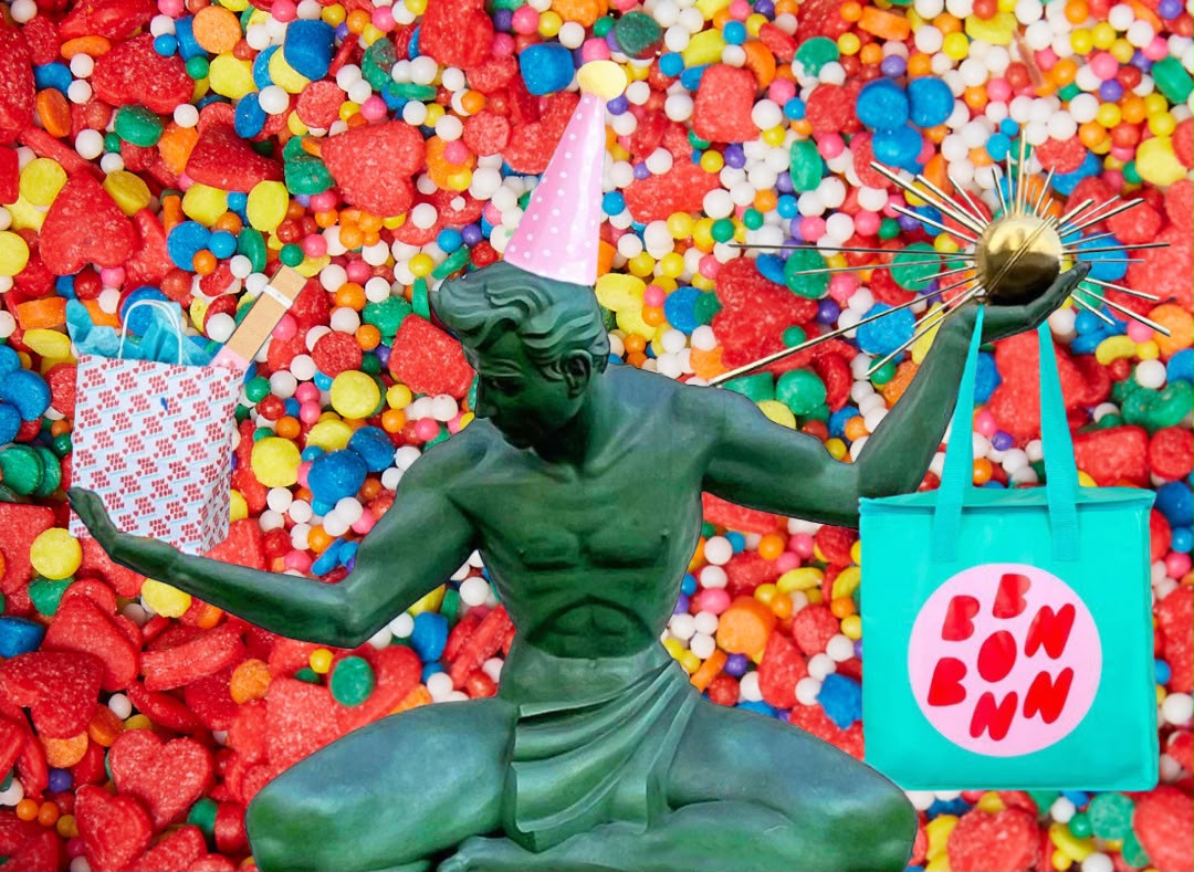 Spirit of Detroit statue edited to be holding two Bon Bon Bon bags with a birthday hat on
