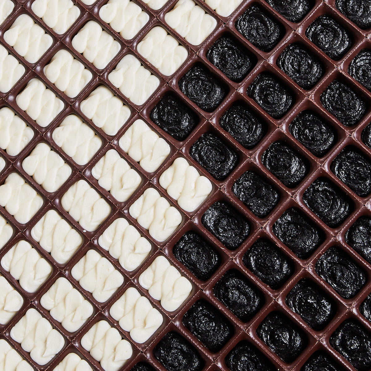 photo looking down at a tray of Bumpy Bons, chocolates filled with cake ganache and buttercream