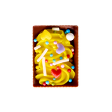 Colorful candy with a yellow swirl in a brown box on a white background