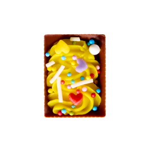 Colorful candy with a yellow swirl in a brown box on a white background