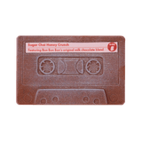 A chocolate cassette tape with 'Sugar Chai Honey Crunch' text and a note mentioning Bon Bon's original milk chocolate blend.
