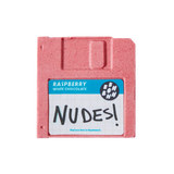 A pink-colored floppy disk-shaped chocolate with a label that reads 'Raspberry White Chocolate' and 'NUDES'.