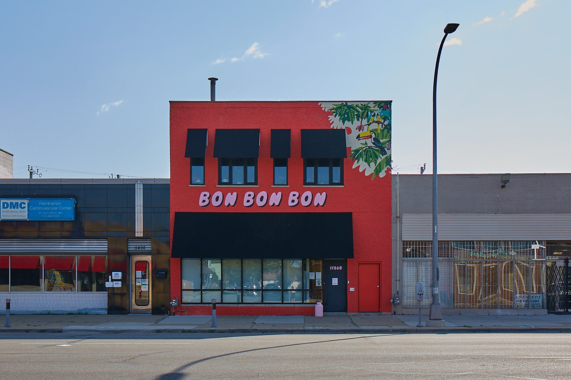 Red building with 'Bon Bon Bon' sign on a clear day